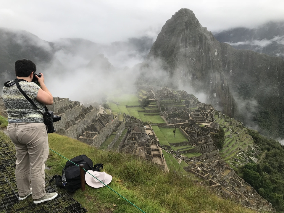Stone walls in a lush green landscape.