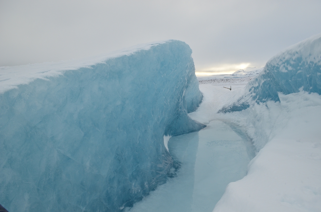 Vue d'une crevasse glacée dans un glacier avec de la glace bleue transparente.