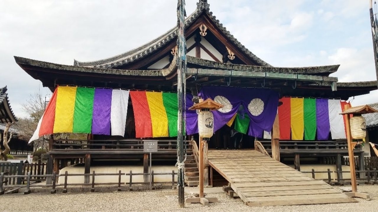 Colorful banners on a traditional Japanese building.
