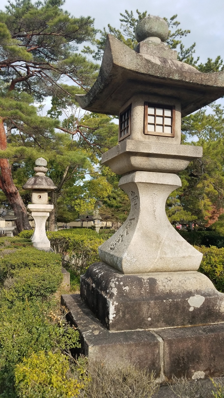Traditional stone lanterns in a Japanese garden.