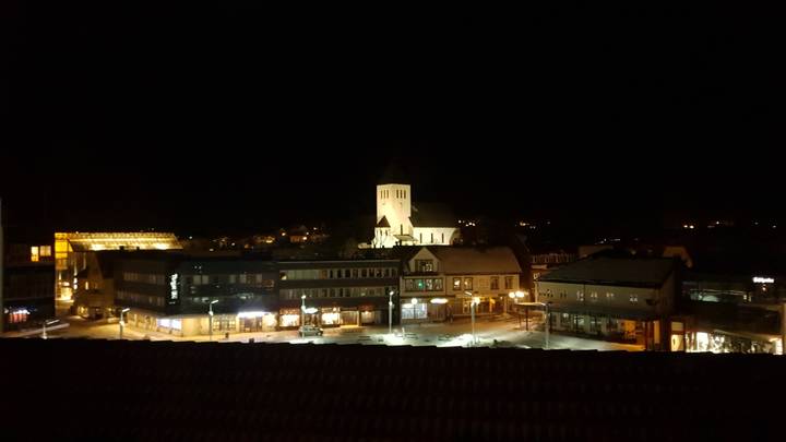 Night view of a town square with a church.
