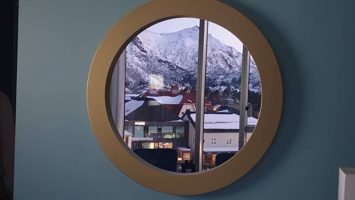 Mountain view through a round window.