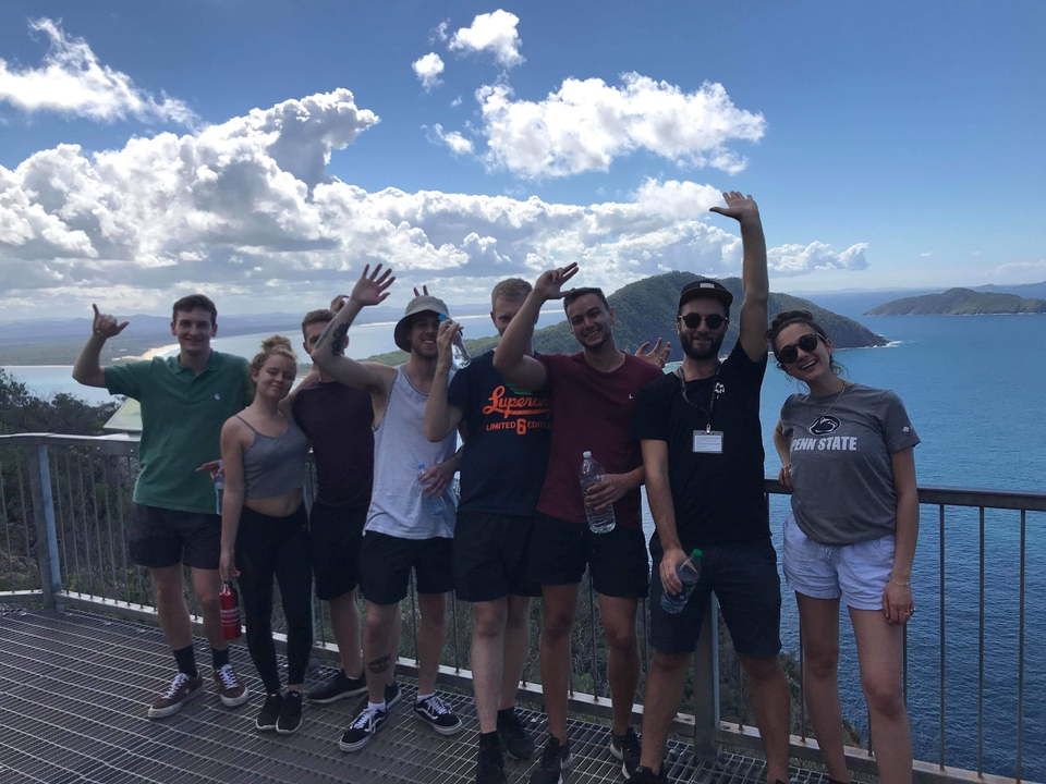 Group of friends posing with a stunning coastal view.