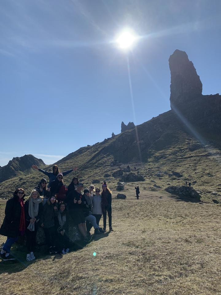 Group of people enjoying a scenic landscape view.