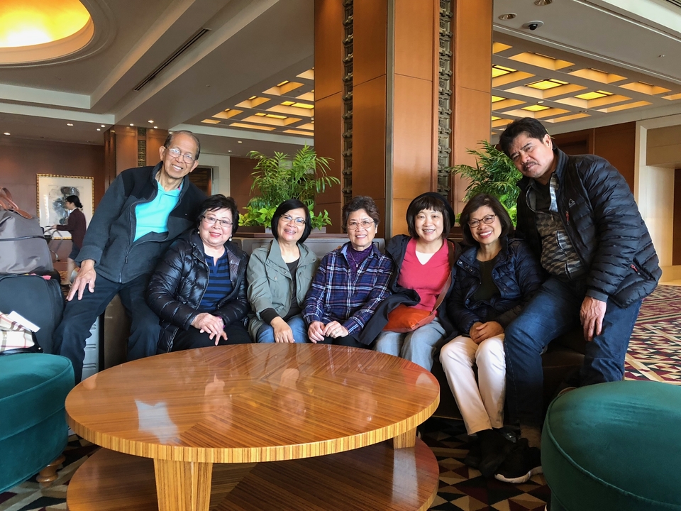 Photo de groupe intérieure de sept personnes souriantes.