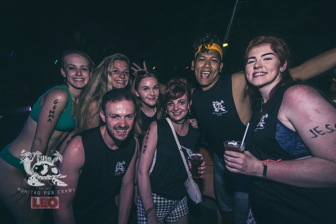 Group of friends at a nighttime event with watermarks.
