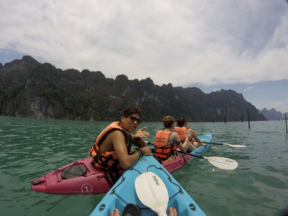 Kayakers enjoying a day on the water with scenic mountainous backdrop.