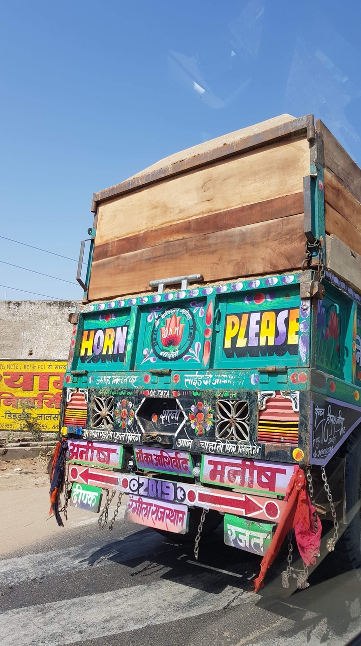 Camion coloré avec des motifs complexes et le texte « Horn Please ».