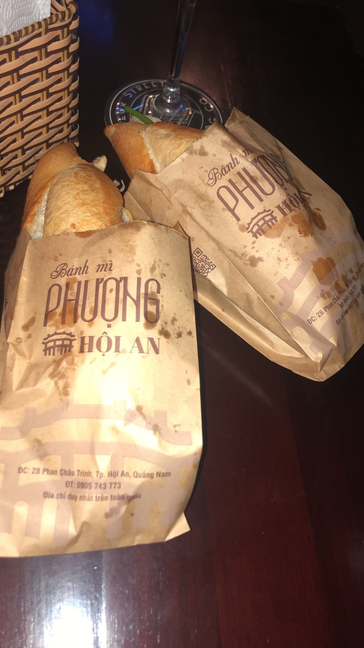 Gros plan de sandwichs Bánh mì dans des sacs en papier.