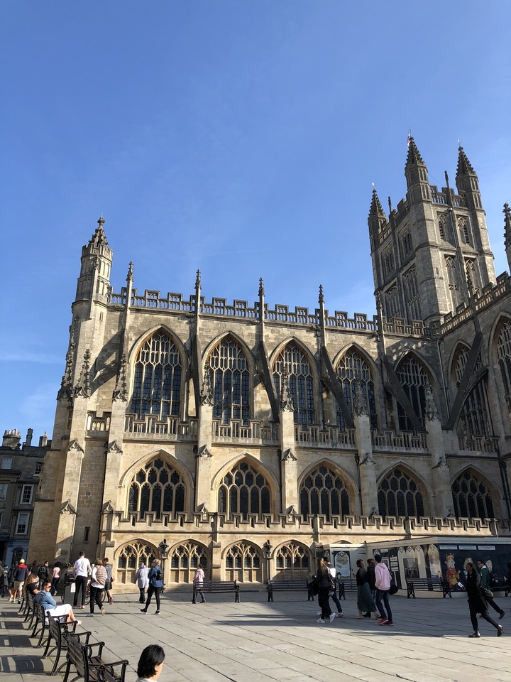 Gothic abbey under clear blue sky.