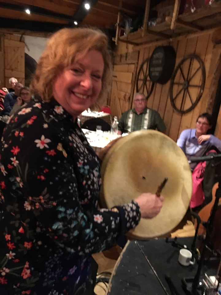 Personne jouant un tambour traditionnel lors d'un rassemblement.