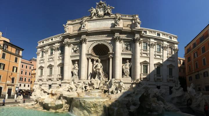 Trevi Fountain with sculptures and cascading water.