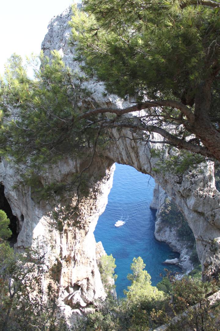 Natural rock arch with a view of the sea in Capri.