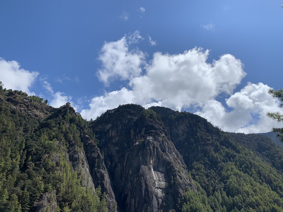 Formations rocheuses de falaises avec des structures au sommet et un ciel bleu dégagé.