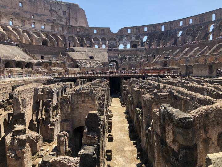 Interior view of the ancient Colosseum with tourists.