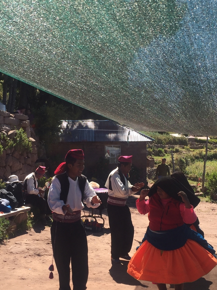 A group of people in traditional attire in a rural setting.