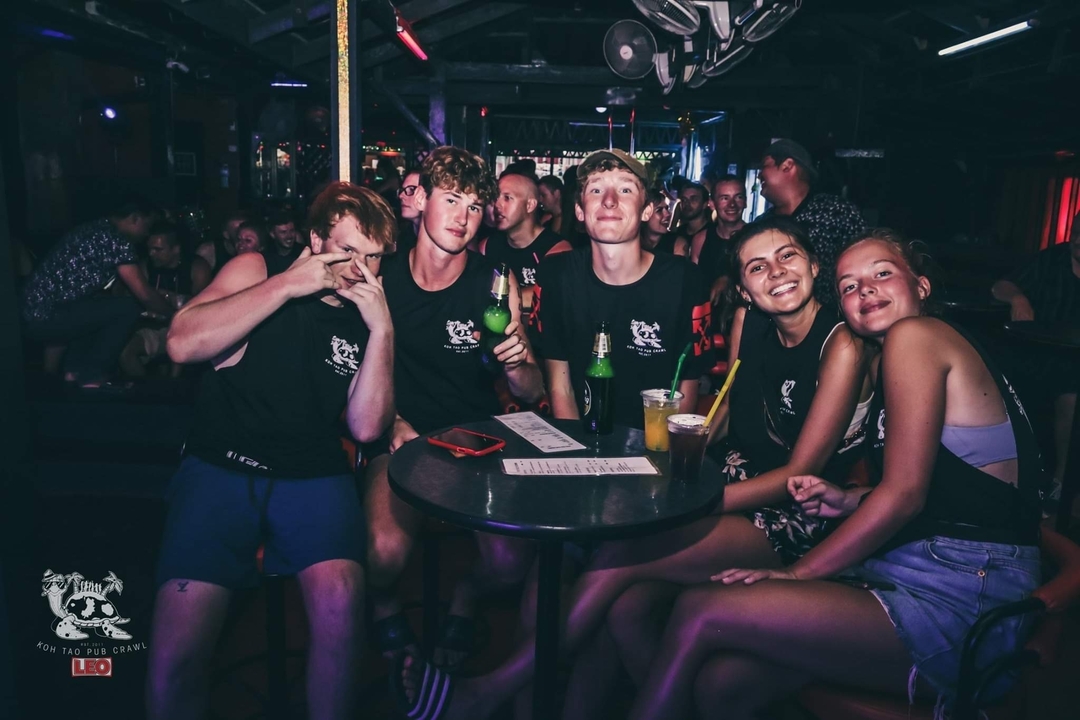 Group of friends at a party or bar with drinks.