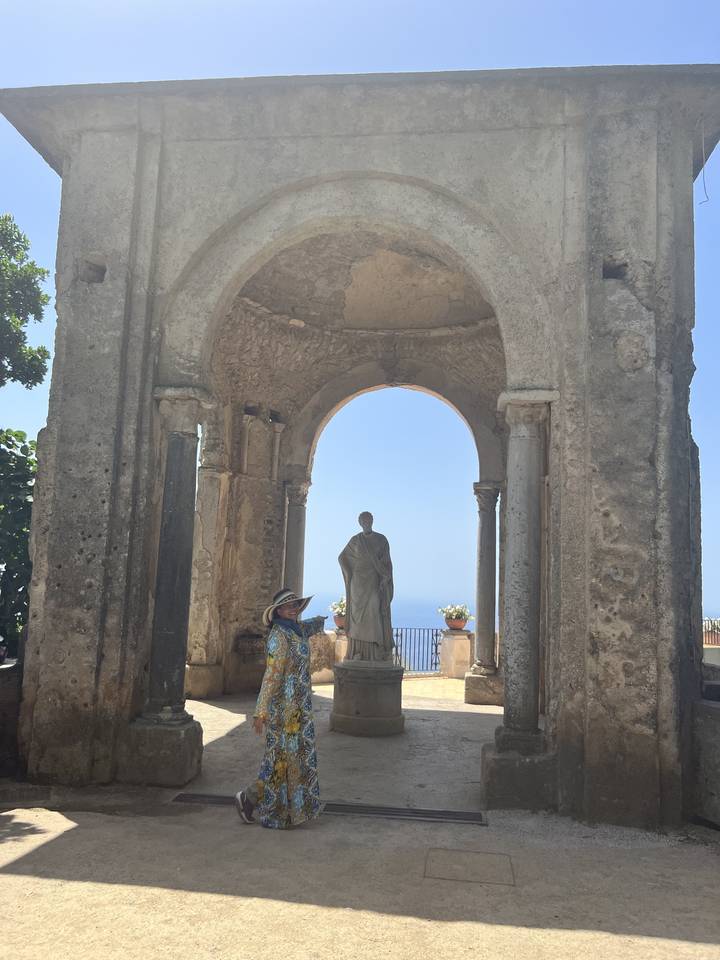 Personne marchant sous des arches historiques.