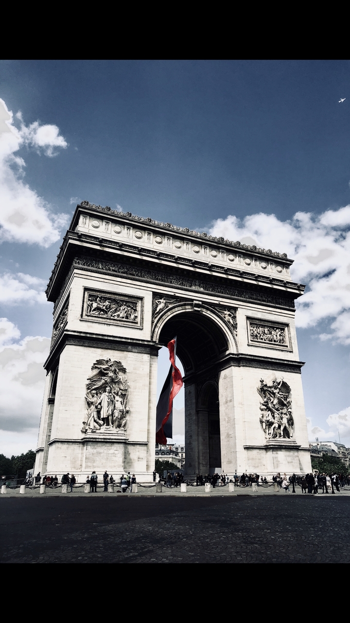The Arc de Triomphe captured from an angle showing detailed sculptures.