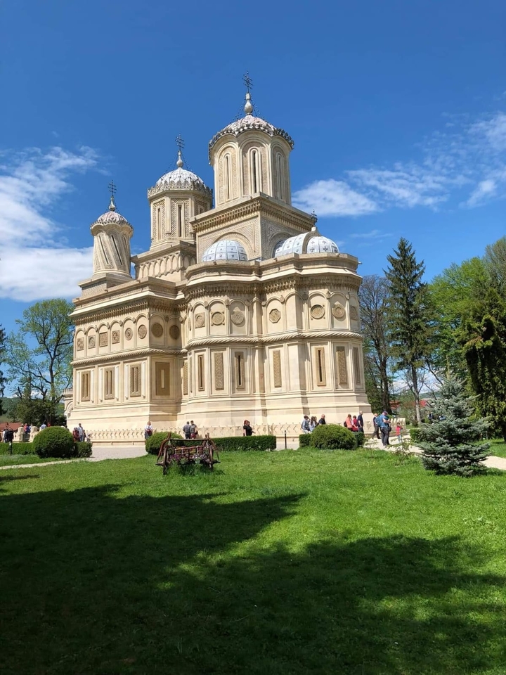 Grand bâtiment architectural avec des touristes autour.