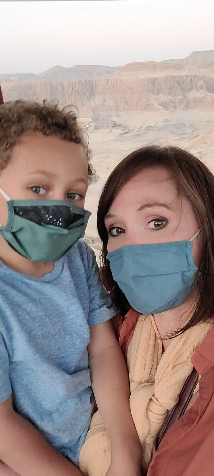 Two people wearing face masks, looking at the camera.