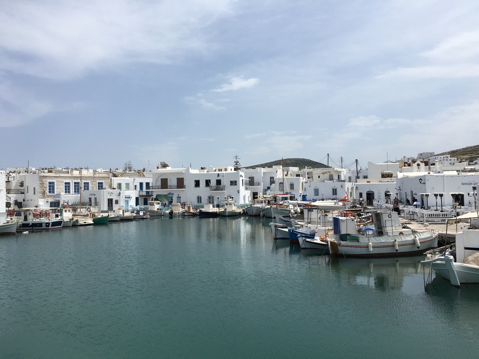 Bâtiments blanchis à la chaux et bateaux dans un port pittoresque.