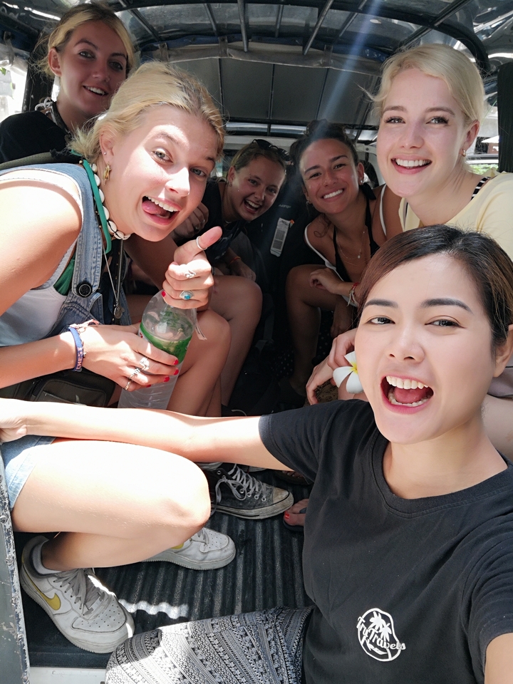 Groupe d'amis souriant et assis ensemble.