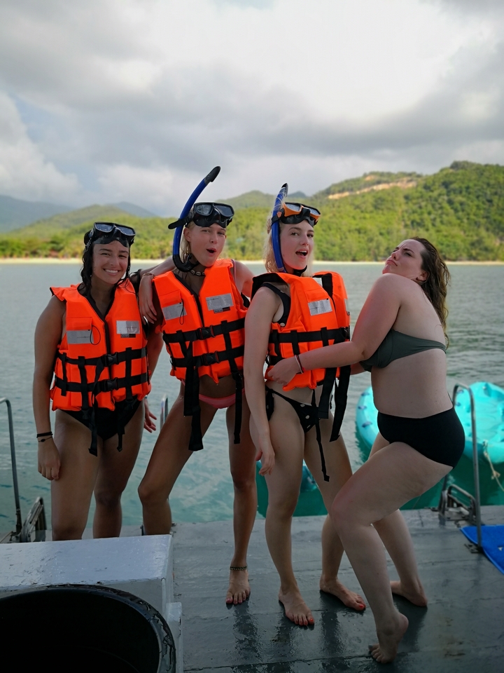 People wearing life vests preparing for water activity.