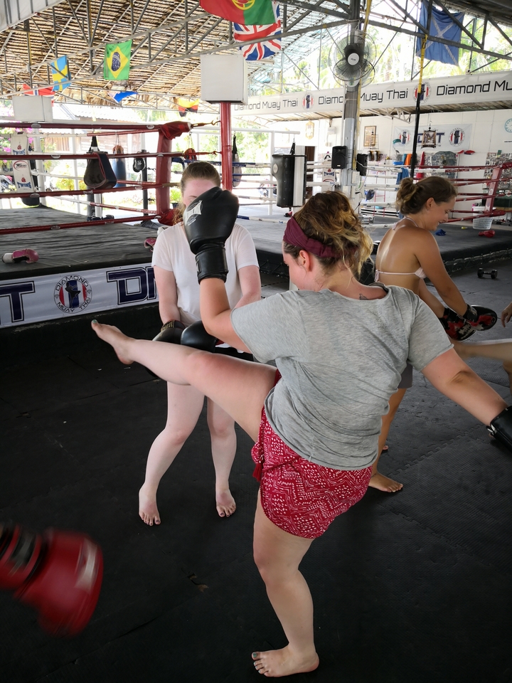 People practicing kickboxing in an indoor training area.