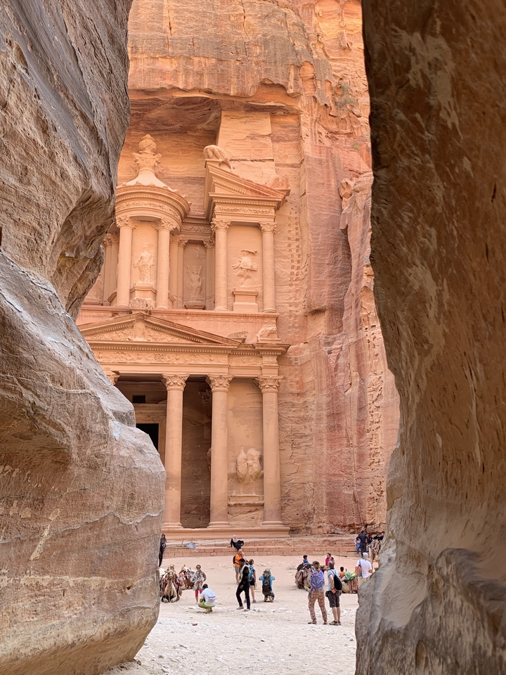 Majestic view of Al-Khazneh with sandstone cliffs.