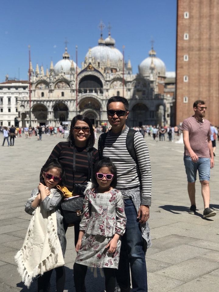Famille posant devant la basilique Saint-Marc à Venise.