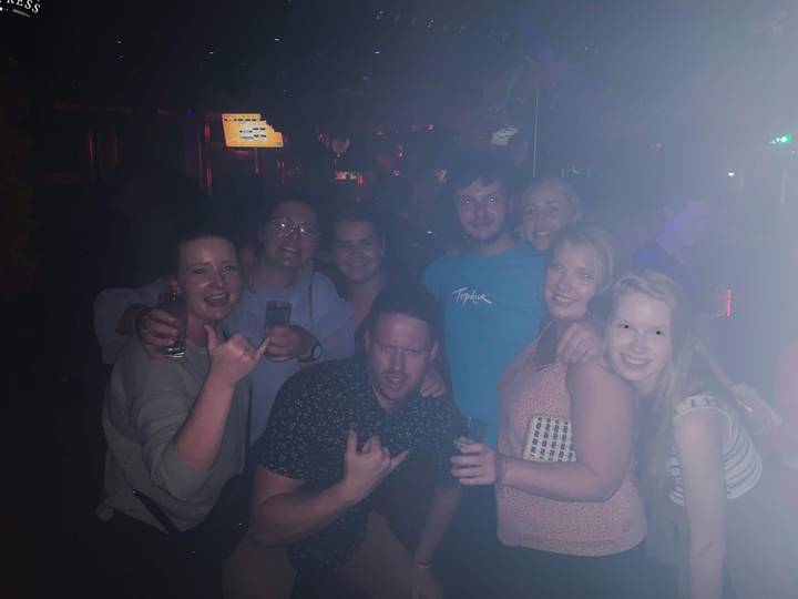 Group of people in a dimly lit bar.