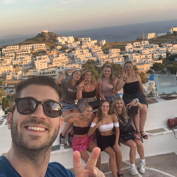 Group of young people posing with a city view.