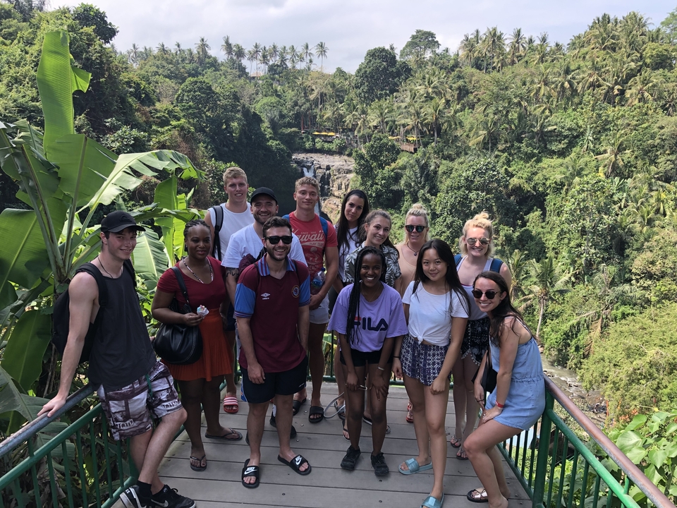 Group of people standing on a scenic overlook.