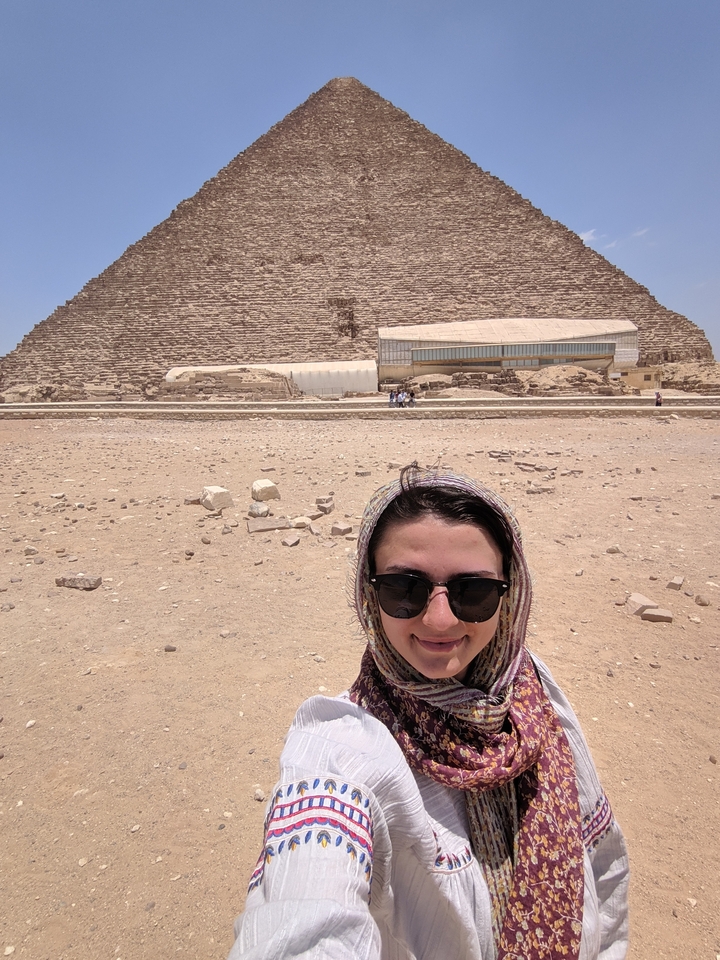 Woman posing in front of the Step Pyramid of Djoser.