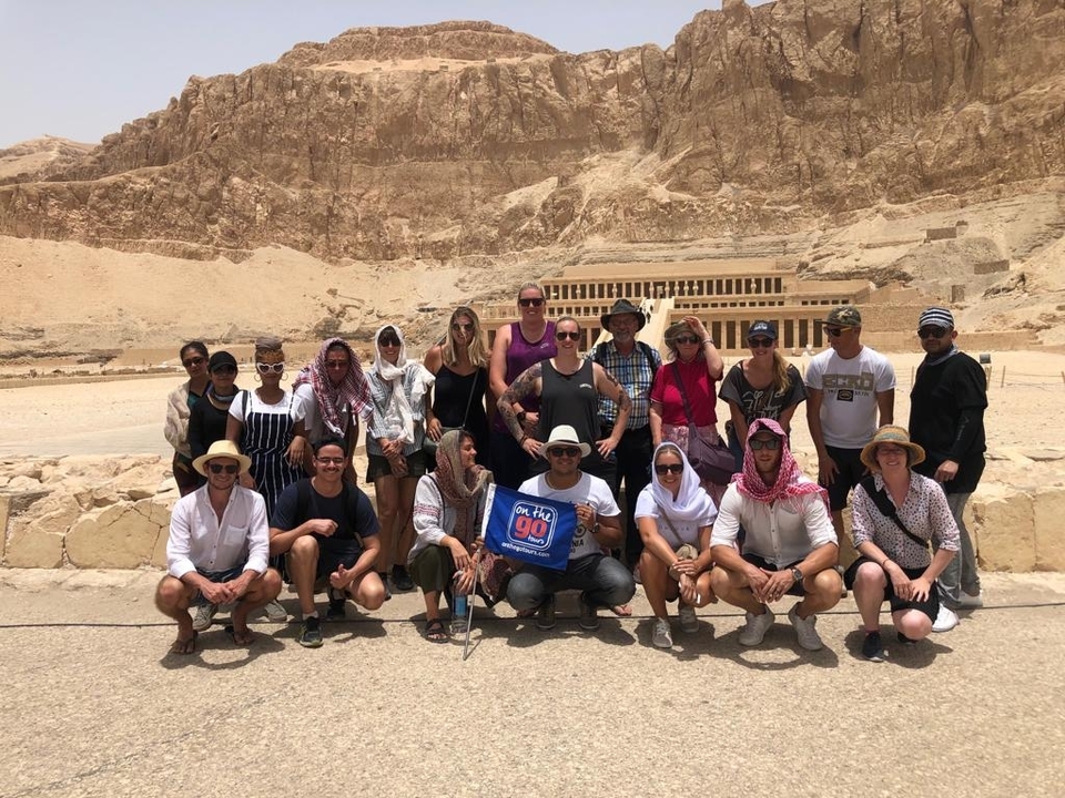 Group of people posing in front of an ancient temple.