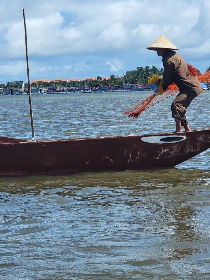 Personne ramant dans un bateau sur une rivière.