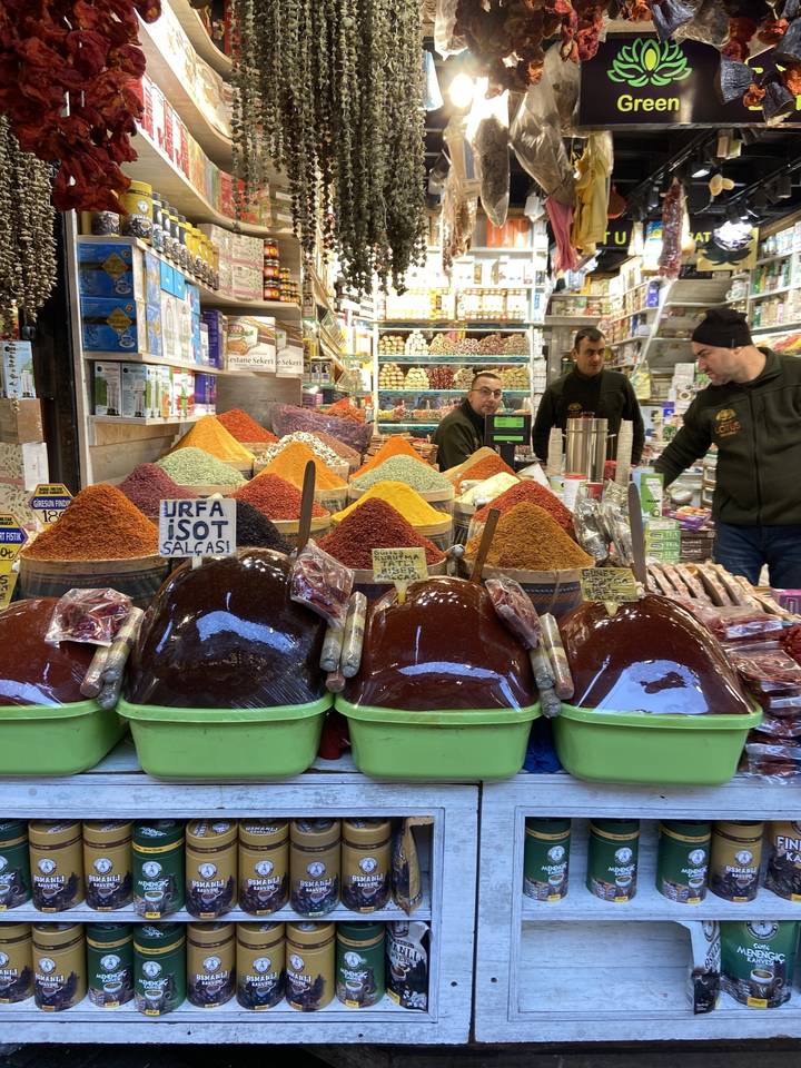 Étal de marché avec des épices colorées exposées.