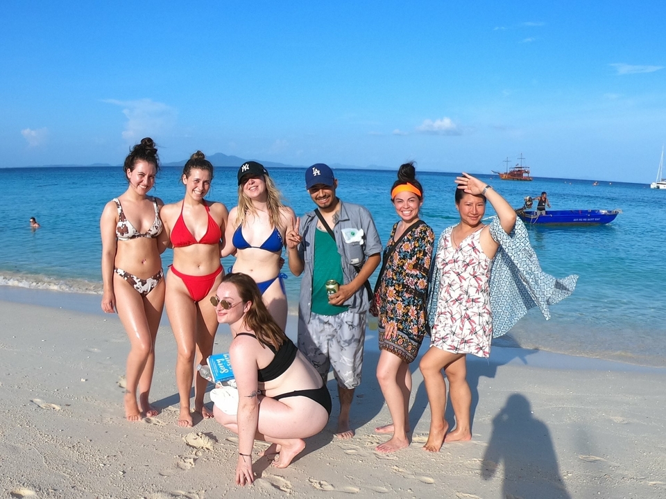 Group posing on a sandy beach