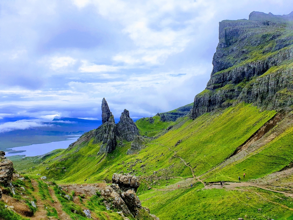 Rock formations and green hillsides in a dramatic landscape.