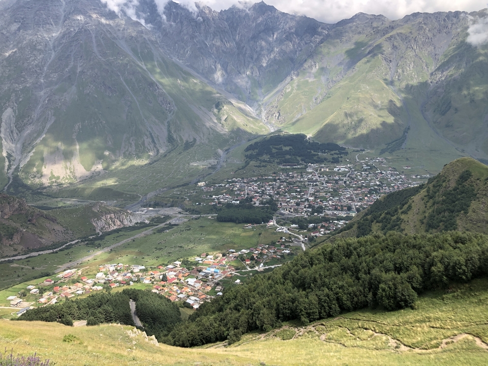 Vue aérienne d'un village dans un paysage montagneux.