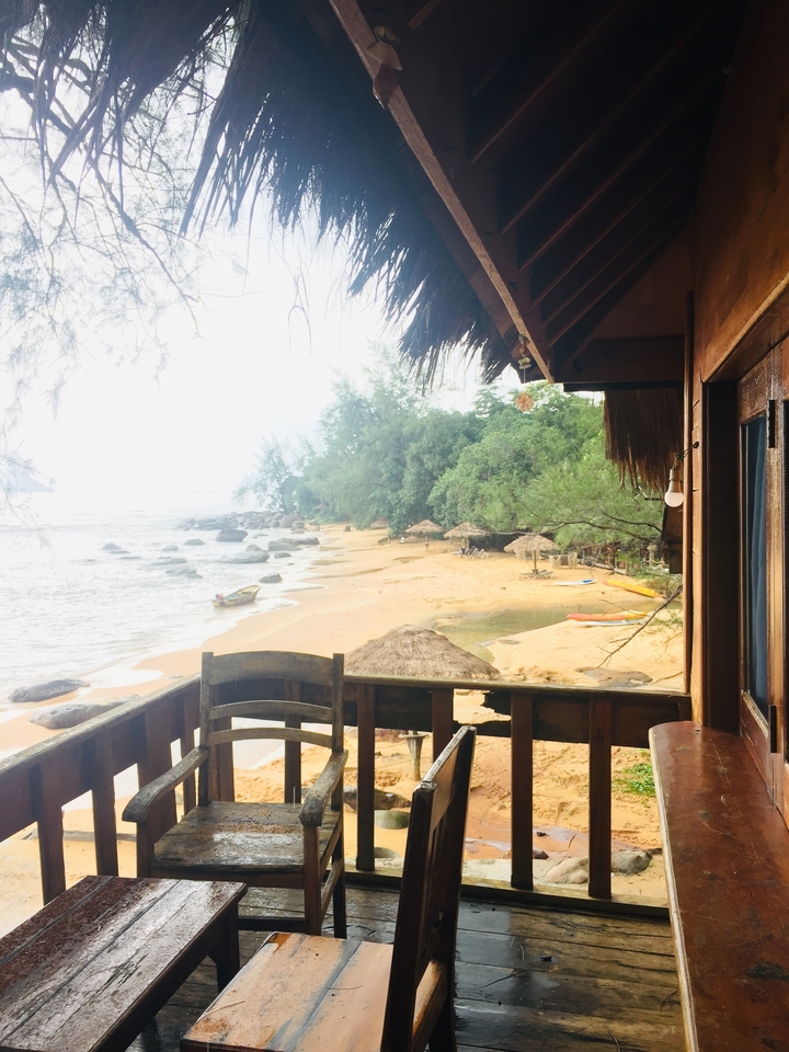 Vista desde una cabaña frente a la playa con vista a la orilla arenosa y el océano.