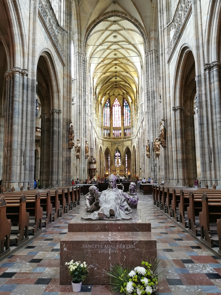 Intérieur d'une cathédrale gothique avec des vitraux lumineux.