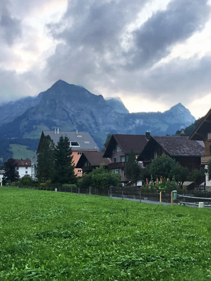 Charmant village avec des maisons traditionnelles et un arrière-plan montagneux.