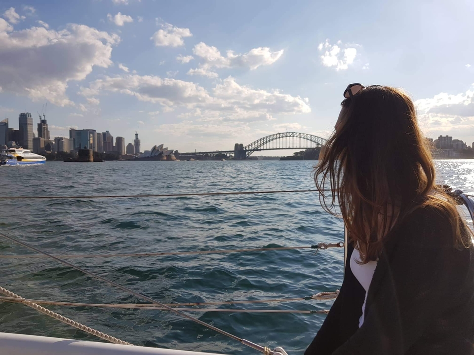 View of Sydney Opera House and Harbour Bridge from a boat.
