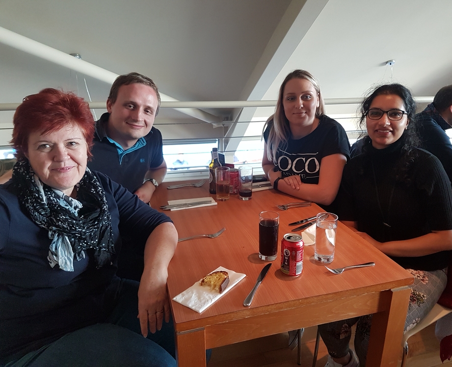 Un groupe de quatre personnes assises autour d'une table dans un restaurant.