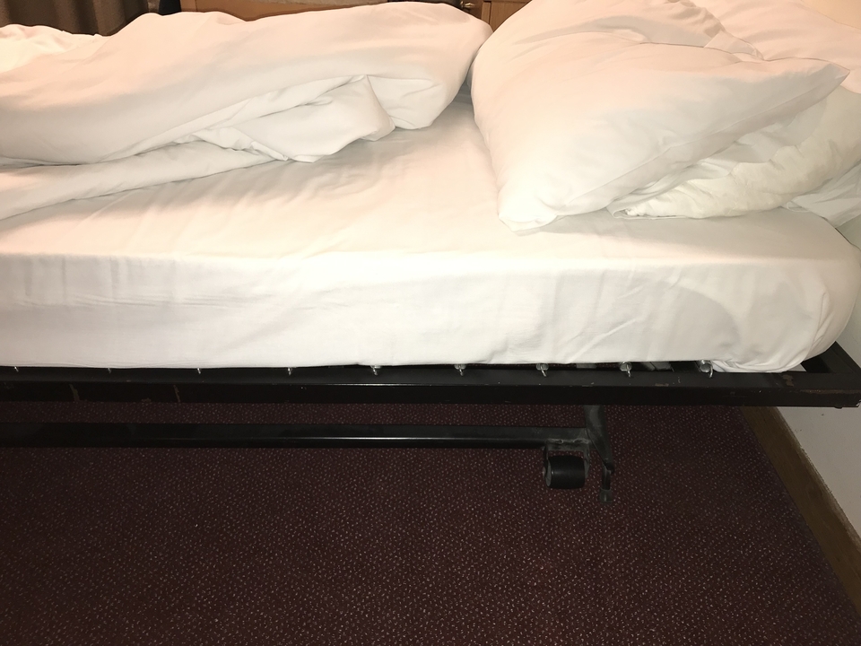 Gros plan d'un lit avec des draps blancs