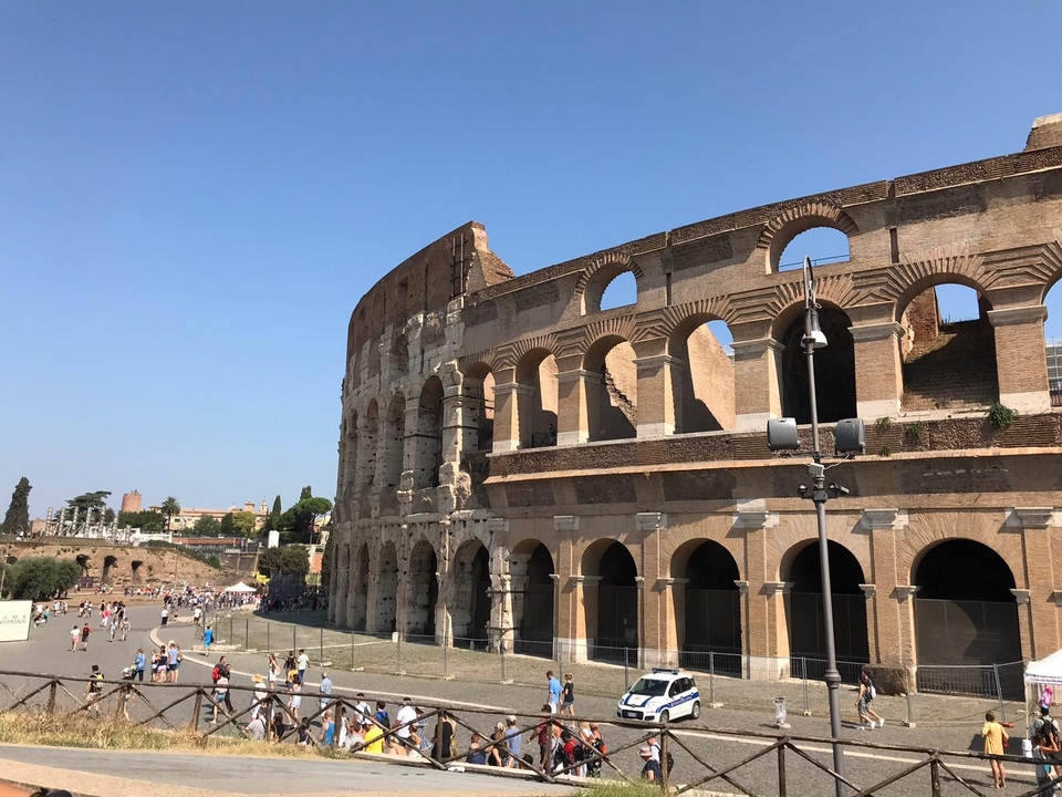 Le Colisée à Rome avec des touristes qui se promènent à proximité.