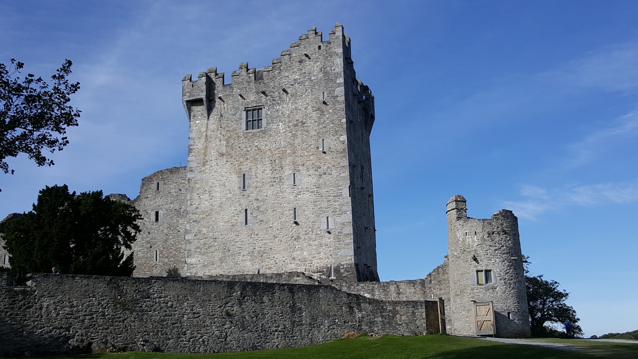 Un château de pierre historique sous un ciel dégagé.