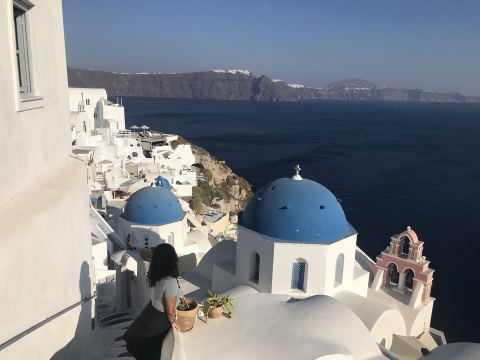 View of Santorini with white buildings and blue domes.